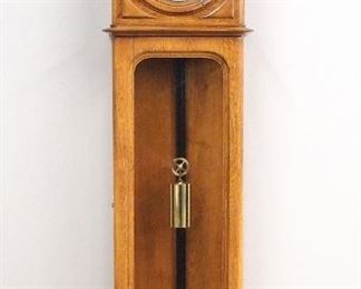 A late 19th century Vienna wall clock.  30-day one weight movement with porcelain chapter ring, Roman numerals and a Brass dial center.  Oak case with molded top over two doors the dial door with applied circular molding and corner panels, the lower with molded inside edge with radiused corners and a flat molded base.  Refinished with minor wear, running when cataloged.  54" high overall.  ESTIMATE $1,000-2,000