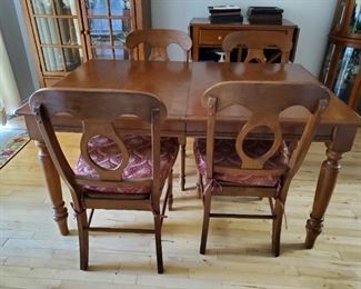 Solid wood table with four upholstered chairs