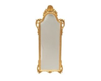 Italian gilt wood mirror, having arched mirror face, supported in frame with carved shell and scroll accents, marked "made in Italy" 53 1/2"h x 18"w x 1"d 