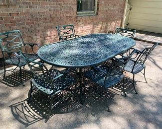 Metal table and six chairs with two sets of cushions.