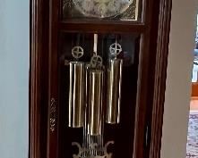 Lovely Grandfather Clock by Bulova. In working condition and measuring 23" x 11" x 80"
