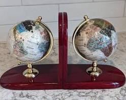 Inlaid Stone Rotating Globe Bookends. Each 7” wide and 7.5” high.