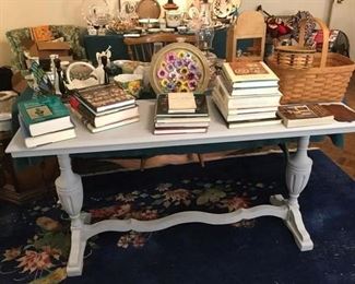 PAINTED LIBRARY TABLE, ON TOP ARE MANY BOOKS ON ANTIQUES FROM THE HOME OWNER'S COLLECTION AND TWO LONGABERGER BASKETS