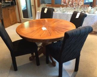 Another view of the Claw Foot Dining Table and 4 of 6 Black Upholstered Chairs.