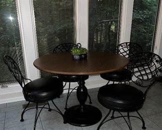 Round pedestal table; 4 swivel iron side chairs