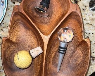 Wood bowl with various wine stoppers