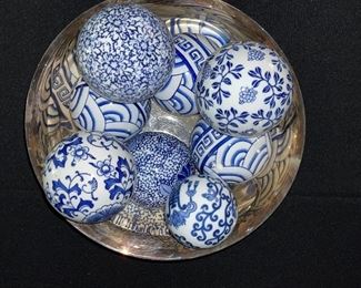 Blue and white carpet balls in silver plate bowl