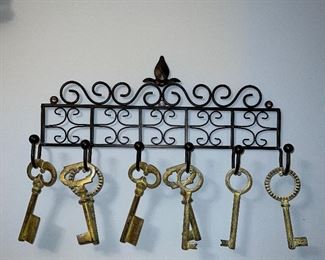 Metal wall holder; various large decorative keys