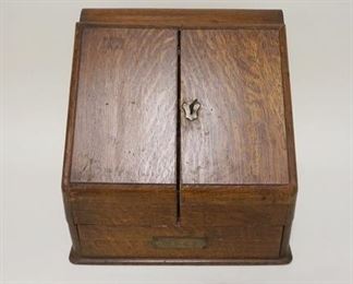 1005 ANTIQUE OAK TABLE TOP STATIONARY BOX, SLANT FRONT W/COMPARTMENTS & CALENDER, DRAWER AT BASE, APPROXIMATELY 13 1/2 IN X 10 IN X 13 IN HIGH