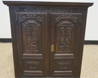 1222 ANTIQUE CONTINENTAL 2 DOOR CARVED CABINET W/DATE OF 1771 ON TOP, 2 CARVED PANELED DOORS, CASE HAVING REEDED COLUMNS & INTERIOR SHELF W/2 LOWER DRAWERS, APPROXIMATELY 12 1/2 IN X 31 IN X 32 1/2 IN HIGH