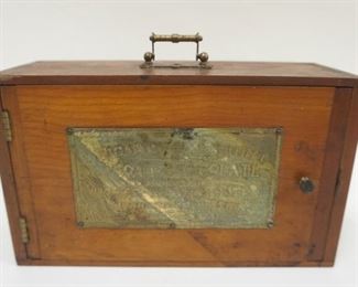 1277 ANTIQUE BAKERS CHOCOLATE EDUCATION KIT, DOVETAILED WOOD BOX WITH EMBOSSED BRASS PLATE ATTACHED TO FRONT WITH DISPLAY MINATURES AND JARS, USED AS AN EXHIBIT, APPROXIMATELY 9 1/2 IN X 3 3/34 IN X 5 1/2 IN HIGH