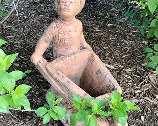 Little child with wheelbarrow garden statue