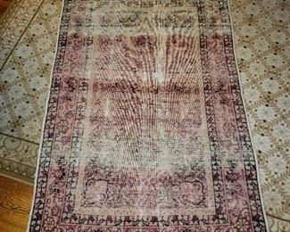 Persian area rug, worn