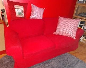 Couch is  cream tan color , red covers & white covers available