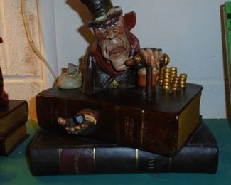 Scrooge sitting on 2 books