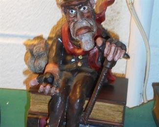 Scrooge sitting on books