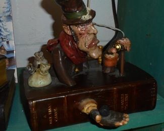 Scrooge sitting on one book