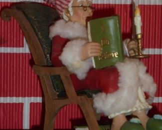 Scrooge in rocking chair reading 'I Do Believe'