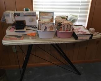 Singer Sewing machine, patterns, notions, etc along with ironing board