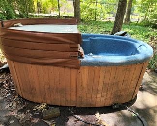 2 person hot tub. In good condition but needs a little cleaning. Has been covered with tarps over cover. Fills with hose, no plumbing needed. Buyer responsible for moving. There is a paved path from hot tub location to driveway for loading.