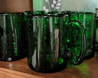 Green glass mugs handmade in Sweden.