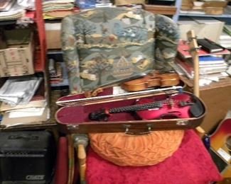 Violin cases, violins, guitars, music books. 