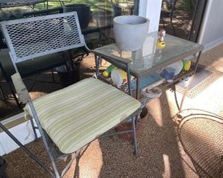 Patio chair with attached two-shelf table 