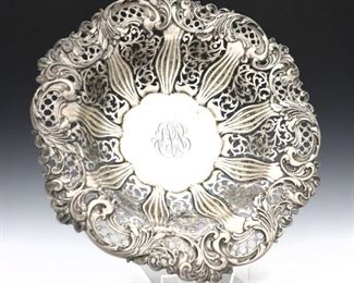 An early 20th century Whiting Sterling Silver center bowl retailed by Charles Billing & Sons. Round form with intricate pierced design and acanthus leaf repousse decoration. 25.56 troy ozs total weight. Monogrammed, minor surface wear. 13" diameter and 3" high. ESTIMATE $400-600
