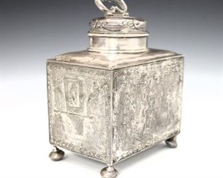 A late 19th century Hanau Sterling Silver tea caddy by Berthold Mueller. Square form with hinged lid and four repousse scenes depicting a wedding procession, on flattened bun feet. Impressed marks. 12.43 troy ozs total weight. Monogrammed, minor surface wear, distortion to feet. 4 1/2 x 3 1/4 x 6" high overall. ESTIMATE $300-400