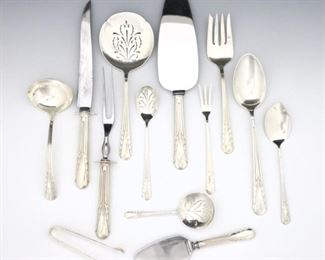 One hundred thirty-seven pieces of International "Orchid" pattern Sterling Silver flatware. Features 6 complete 11-piece place settings plus additional flatware and serving utensils. Includes 12 x 9 1/2" dinner knives, 11 x 8 1/2" luncheon knives, 12 x 5 1/2" butter knives, 12 x 7 3/4" dinner forks, 12 x 7" luncheon forks, 12 x 6 1/4" salad forks, 8 x 7 1/4" place spoons, 12 x 7 1/2" iced tea spoons, 12 x 6" soup spoons, 6 x 5 3/4" teaspoons, 10 x 4" demitasse spoons, plus 18 serving utensils. Impressed marks. 130.59 troy ozs plus 37 hollow handles, approximately 149.09 troy ozs total Sterling weight. Monogrammed, some surface wear. ESTIMATE $2,000-3,000