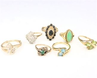 Seven 10k Gold rings with Diamonds, Midnight Blue Sapphires, Emeralds, Jade, Peridot and Topaz stones. Each marked or tested. 22.2 grams total weight. Some wear. Sizes 4 1/4 to 9 1/2. ESTIMATE $300-500