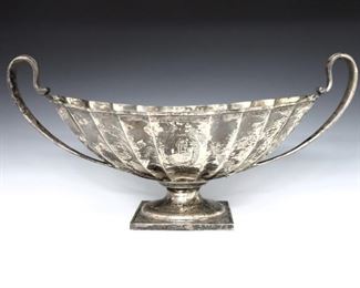 A late 19th century Durgin Sterling Silver center bowl. Oval form with scalloped body, etched floral decoration and two handles on a flared foot with square base. Impressed marks. 32.76 troy ozs total weight. Monogrammed, minor surface wear. 16 1/2 x 8 x 8" high overall. ESTIMATE $600-800