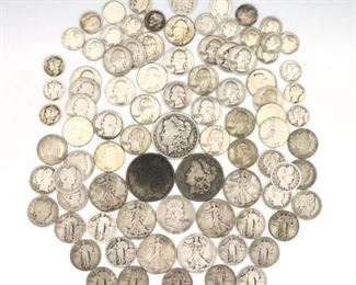 A group of eighty-eight U.S. Silver coins. Includes three Silver Morgan Dollars (1887, 1889, 1921), six Walking Liberty Half Dollars (1917-47), one Franklin Half Dollar (1953), twelve Barber Quarters (1906-15), thirteen Standing Liberty Quarters (1925-1930), twenty-nine George Washington Quarters (1932-64), six Mercury Dimes (1927-41), seventeen Roosevelt Dimes (1947-1964) and one Buffalo Nickel (1934). Various stages of wear and discoloration, several dates worn away. Up to 1 1/2" diameter. ESTIMATE $600-800
