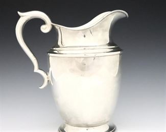 A 20th century Alvin Sterling Silver water pitcher. Footed urn form with scrolled handle. Impressed marks. 22.05 troy ozs total weight. Minor surface wear. 9" high. ESTIMATE $400-600