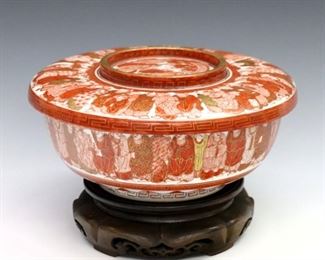 A Japanese Meiji Period porcelain bowl and underplate.  Round form with hand-painted Red decoration and Gilded detail depicting the "Thousand Faces" design with a central Immortal and dragon among clouds.  Impressed marks.  Minor wear to decoration.  Bowl is 8 1/2" diameter and 3 1/2" high, underplate is 9 1/4" diameter, 4 1/2" high overall with stand.  ESTIMATE $400-600
