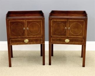 A pair of Baker Hepplewhite style bedside tables from the Historic Charleston Collection. Mahogany construction with Satinwood banding, galleried tops over two hinged doors and tall legs. Original finish with slight wear and minor surface dings, refinished tops. Each 22 x 16 x 32" high overall. ESTIMATE $600-800 pr