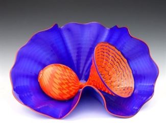 Dale Chihuly, American, b. 1941.  A contemporary two piece blown Art Glass sculpture.  Nesting seaforms in Royal Blue and Orange glass with waved and pulled ribbon designs.  Etched "Chihuly" signature and "PP 06" on inner Orange piece.  No flaws noted.  Sculpture is approximately 11 1/2 x 8 x 6" high, in a custom plexi showcase with some scratches, 12 1/2 x 12 1/2 x 13 3/4" high overall.  ESTIMATE $3,000-4,000