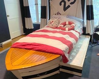 Twin bed  in the shape of a sale boat with twin trundle hide a way below. Area rug below also being sold