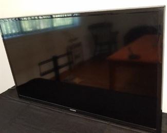 Samsung flat screen TV on stand