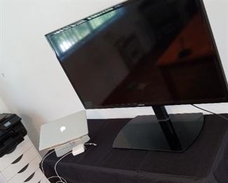 Samsung TV, on stand, Apple Mac ProBook, printer