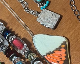 Real butterfly wing inside of case on sterling silver necklace