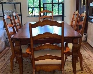 Solid wood dining table with two leaves and 10 chairs excellent condition by Universal furniture/Levin furniture