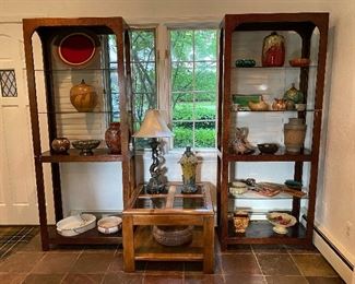 Lots of awesome vintage furniture this photo shows two mid century display shelves with adjustable glass shelves with a tortoise shell painted finish. The center table is an accent table made of solid wood and four square glass inserts. Lots of collectible vintage and mid century pottery!!