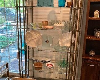 Large iron and glass display shelf and lots of home goods