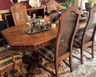 This dining table has 6 chairs and another leaf.