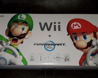Nintendo Wii with Mario Kart game that has NOT been opened.  The box has been opened and the system has been used.  Controller and wheel for the game in the box