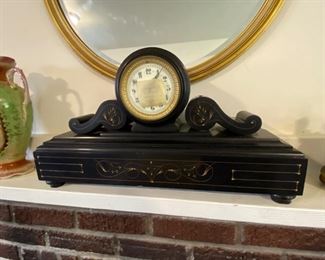Antique black slate empire mantle clock.
