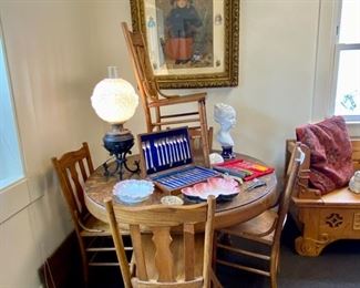 Mission oak round dining room table with 1 insert and six chairs.