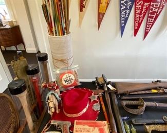 Large collection of vintage feather-tipped archery arrows and toy guns.