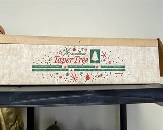 Contains a table-top silver tinsel Christmas tree.